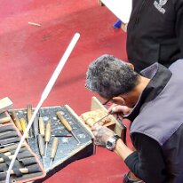 20250503_161047 Some of the artists hard at work on another carving.