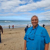 20250411_103426 Ken on the beach at the Memorial Arch on the Great Ocean Road.