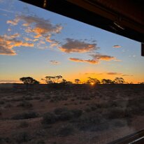 IMG-20250416-WA0010 A view out the train window at sunset.
