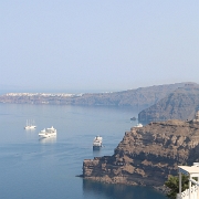 IMG_1717 Our Holland America cruise ship the Zuiderdam can be seen moored below the cliffs of Santorini with the town of Oia in the background.